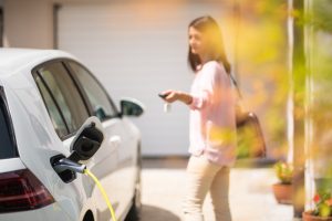 Close,Up,Of,A,Electric,Car,Charger,With,Female,Silhouette